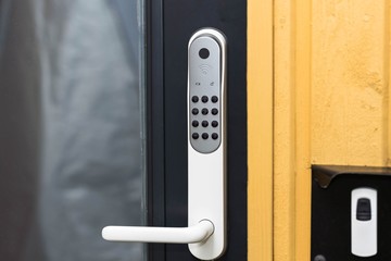 Close up view of an electric combination lock on a black door. Interior design. Beautiful backgrounds.