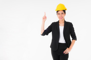 Asian young engineer woman wearing a black suit and Yellow Safety helmet standing .The model stood looking at the camera Right index finger pointing up.copy space isolated on white background studio 
