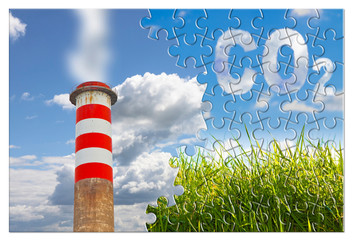 CO2 concept image in jigsaw puzzle shape against a green wild grass on sky background and an high...