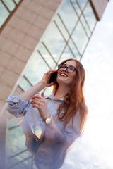 Cheerful young woman talking on mobile phone