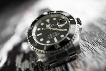 Close-up, abstract and shallow focus view of an iconic, swiss-made men's automatic divers watch...