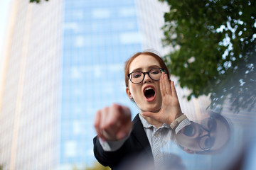 Portrait of excited manager shouting and pointing at camera