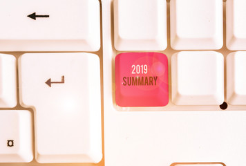 Conceptual hand writing showing 2019 Summary. Concept meaning brief comprehensive especially covering the main points of 2019 White pc keyboard with note paper above the white background