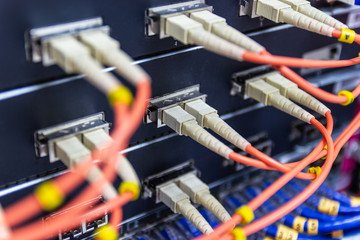 cable network , fiber optic cable connect to switch port in server room , Concept network management
