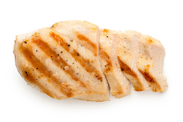 Partially sliced grilled chicken breast with grill marks, ground black pepper and salt isolated on...
