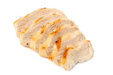 Sliced grilled chicken breast with grill marks, ground black pepper and salt isolated on white.
