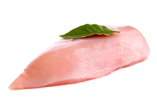 Whole uncooked boned chicken breast with bay leaf isolated on white.