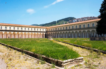 Fototapeta premium One of the cloisters of Padula Charterhouse with Padula hamlet in the background, Salerno, Italy