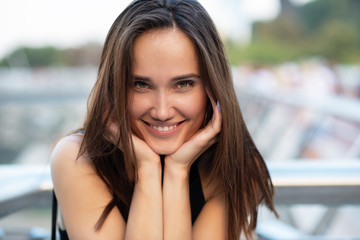 Young pretty likable cheerful woman posing summer city outdoor in Kyiv, Ukraine. Beautiful...