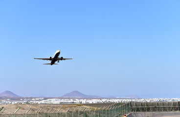 Passenger plane flying goes on takeoff in the blue sky, Lanzarote, Canary Islands, Spain