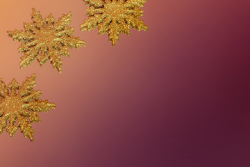 Christmas decoration made of golden snowflakes on a shiny background.