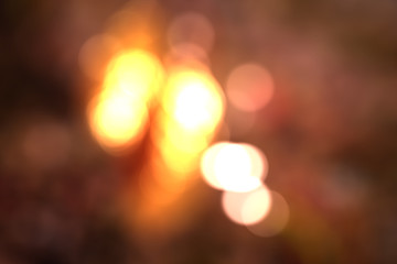 Blur background with shiny bokeh, autumn red, yellow, orange color.