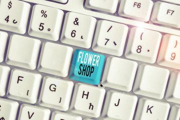 Writing note showing Flower Shop. Business concept for where cut flowers are sold with decorations for gifts White pc keyboard with note paper above the white background