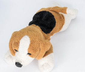 Small brown and black stuffed white dog