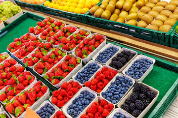 A variety of berries and fruits for sale at street market