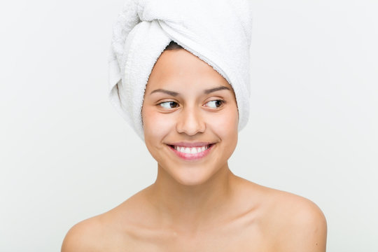 Close up of a beautiful and natural hispanic young woman with a towel on her head