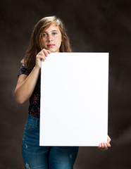 Serious Looking Pre-Teen Girl Holding Blank Vertical White Sign