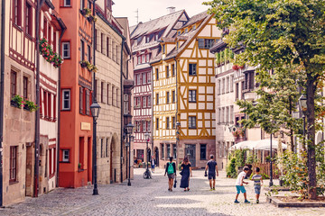 05 August 2019, Nuremberg, Germany: old town street with its traditional half-timbered houses is a popular tourist attraction in Germany. - obrazy, fototapety, plakaty