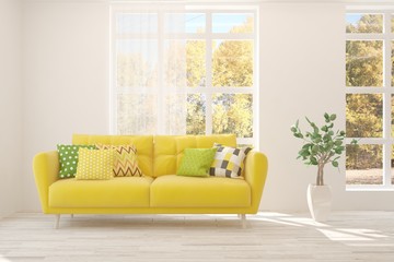 Stylish room in white color with sofa and autumn landscape in window. Scandinavian interior design. 3D illustration