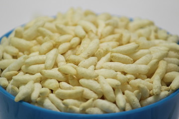 Puffed rice on the blue bowl with white background