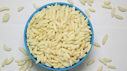 Puffed rice on the blue bowl with white background