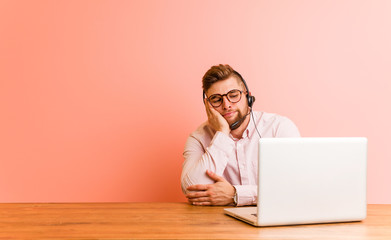 Young man working in a call center who is bored, fatigued and need a relax day.