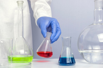 Hand of a scientific taking a sample tube test. Workplace lab assistant.