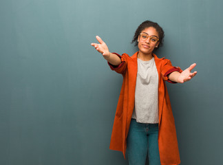 Young black african american girl with blue eyes inviting to come