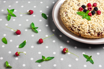Homemade berry shortcrust pie with crumble on plate