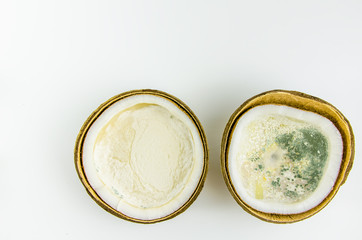 ugly food. old split coconut on a white background