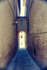 Narrow street in Urbino town in Italy