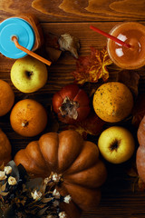 Pumpkins juice in bottles with pumpkins. Glass of pumpkin juice placed on a table near the pumpkins. .