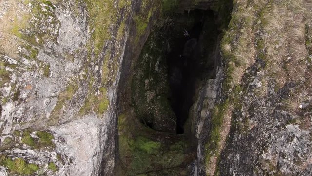 Sumgan-Kutuk karst cave. Descent cavers in the cave. Aerial view.