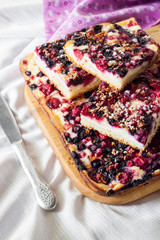 Closeup of berry pie with cottage cheese cut on square slices
