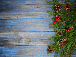 christmas decoration cones and garland lights on wooden background