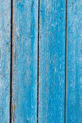 Old and peeling paint Over time, the blue paint peeled off from the old boards and the wood texture cracked. Vintage Abstract Grunge Background