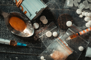 Hard drugs on dark table.Addiction concept. Drug syringe and cooked heroin