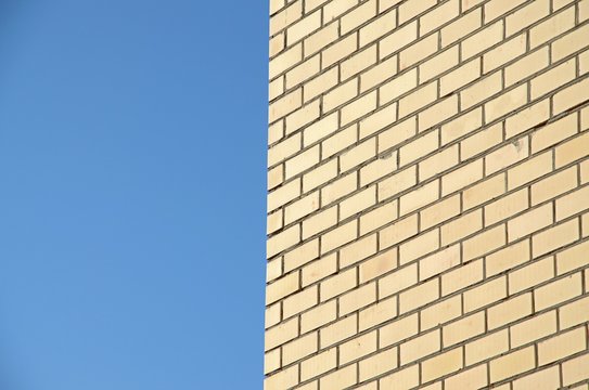 Fototapeta Blue background and part of brick wall. Brickwork, its kind of distant.