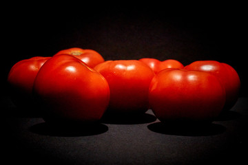 Tomatoes on very black background