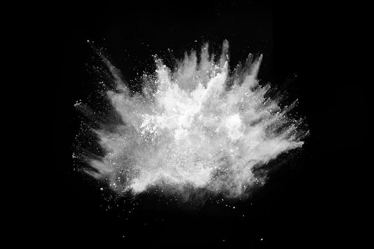 White powder explosion on black background. Colored cloud. Colorful dust explode. Paint Holi.