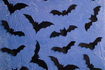 Halloween background. Paper cut bats flying. Top view with copy space.