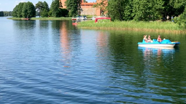 TRAKAI, LITHUANIA - JULY 2017: Tourists enjoy castle on the water. This is a major attraction in Lithuania.