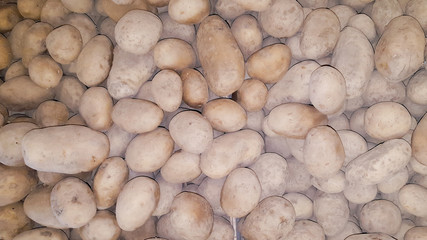 Raw organic potatoes in box market background top view