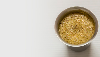 South Indian coffee served in steel glasses - white background with space for text