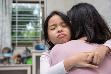 asia sad daughter tightly hugging her mother telling about her problems