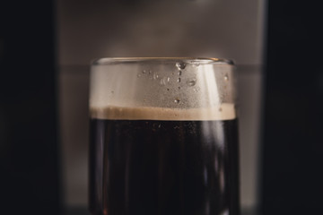 freshly brewed coffee in a glass cup close-up. strong black coffee.