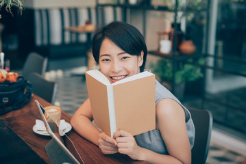 Asian woman drinking coffee in vintasg color tone