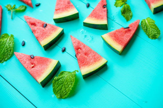 Watermelon slice with papermint on a blue rustic wood background