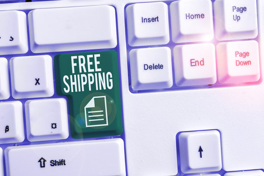 Conceptual hand writing showing Free Shipping. Concept meaning Freight Cargo Consignment Lading Payload Dispatch Cartage White pc keyboard with note paper above the white background