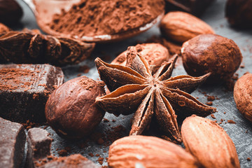 Star anise, chocolate cubes and nuts, close-up view
